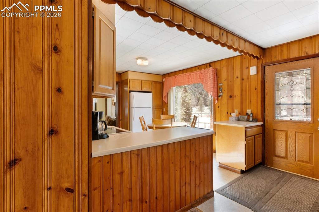 Image 10 of 35: Entry and kitchen