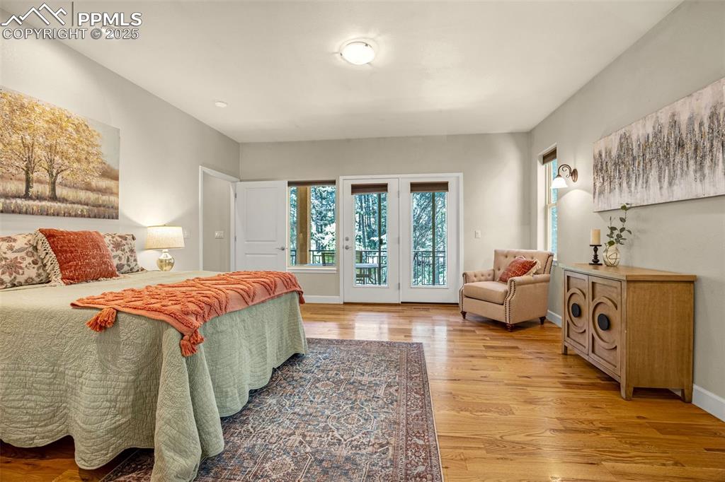 Image 12 of 41: Bedroom with access to outside, light wood-style flooring, baseboards, and
