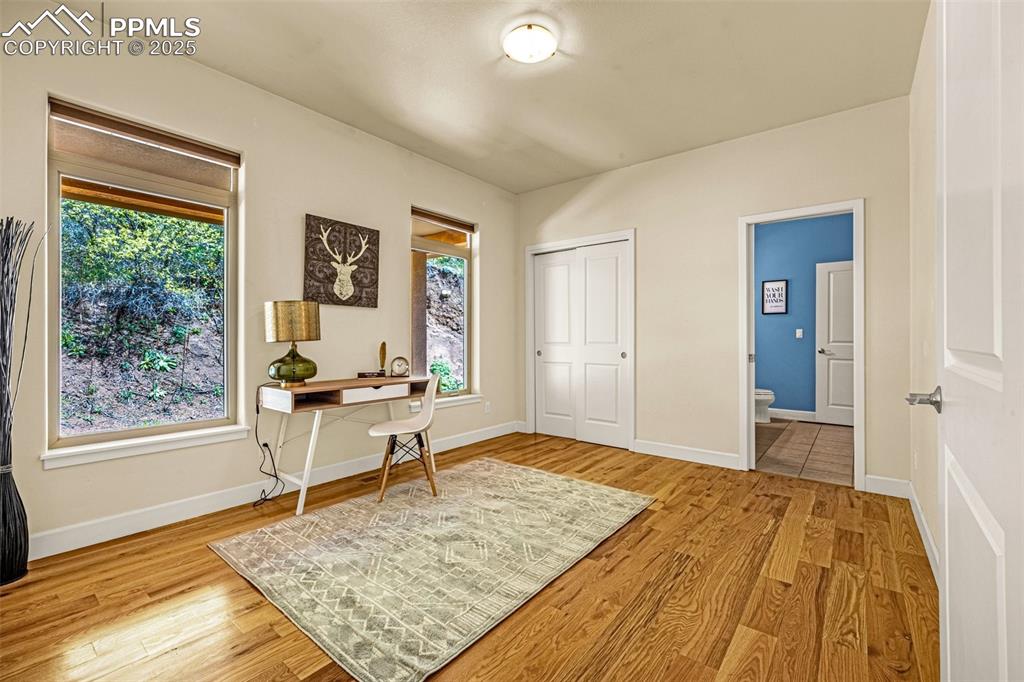 Image 16 of 41: Office space featuring wood finished floors, healthy amount of natural ligh