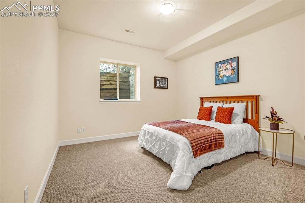 Image 26 of 41: Carpeted bedroom with baseboards