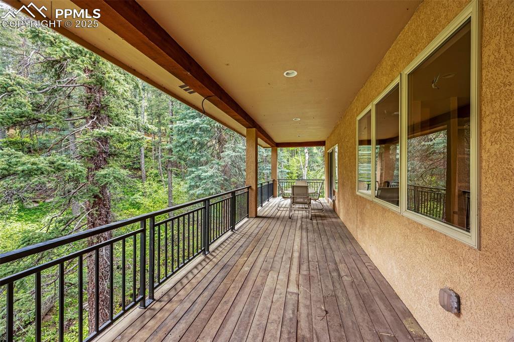 Image 29 of 41: Wooden deck featuring a wooded view