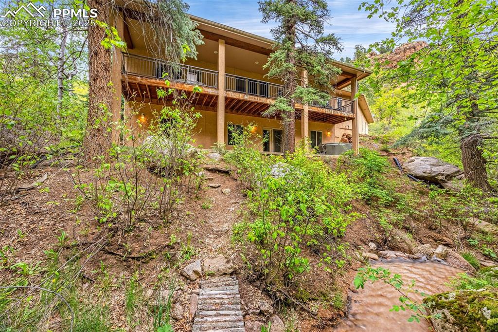 Image 32 of 41: Rear view of house featuring a wooden deck
