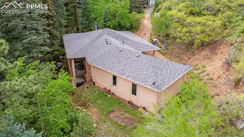 Image 34 of 41: View from above of property with a forest