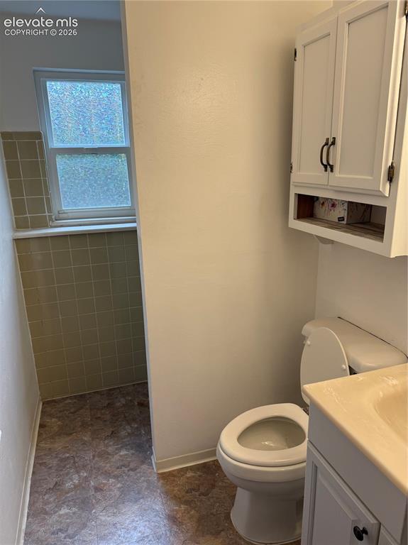 Image 12 of 16: Bathroom featuring a white vanity cabinet, wall-mounted storage cabinet, an