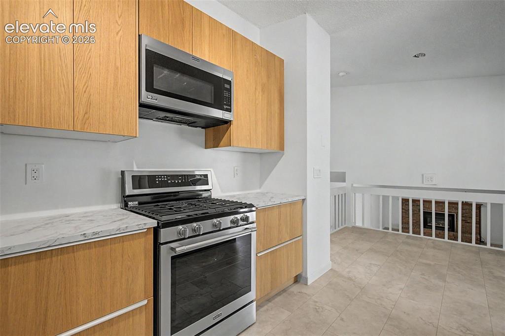Image 10 of 46: Gas Range and New Vented 1000w Microwave