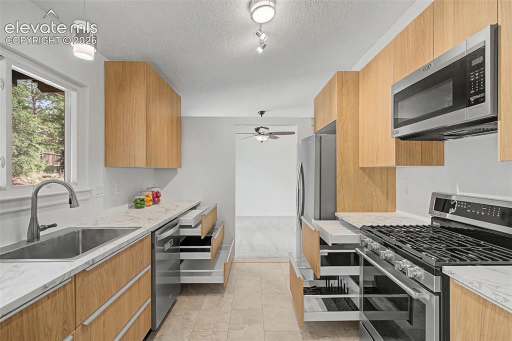 Image 4 of 46: New 42" Cabinets with extra deep storage with hidden storage drawers!