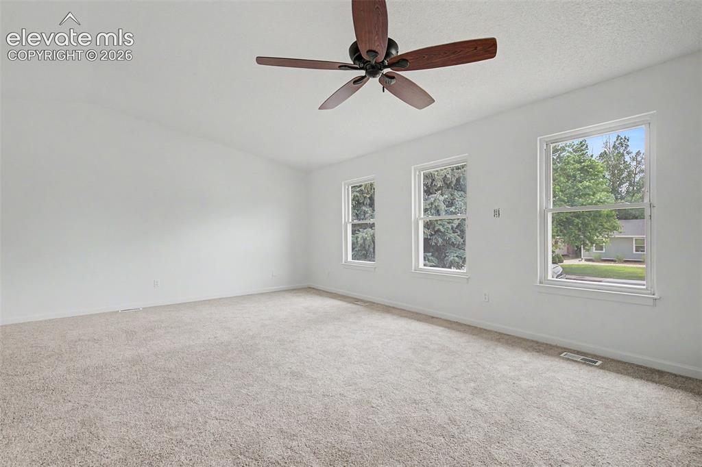 Image 6 of 46: Large Living Room with Vaulted Ceilings to Accommodate Family Gatherings