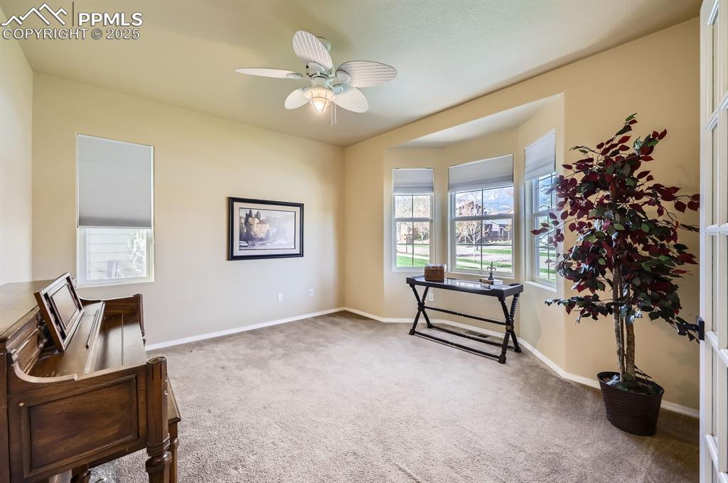 Image 12 of 34: Sitting room featuring carpet flooring, a ceiling fan, and baseboards