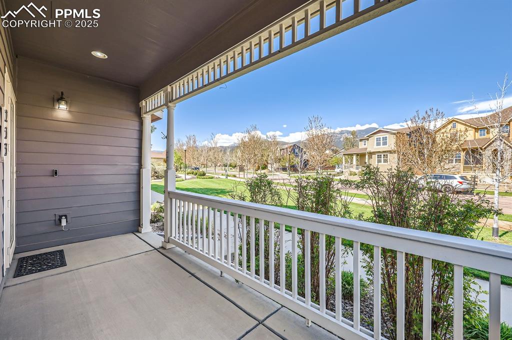 Image 27 of 34: Balcony with covered porch and a residential view