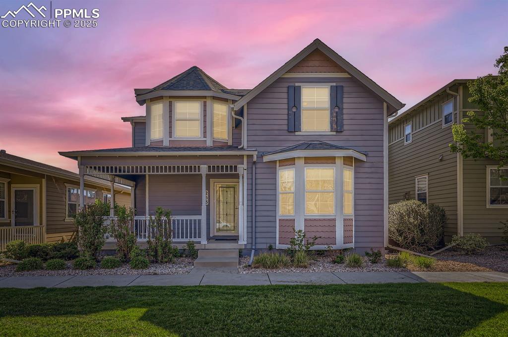 Image 3 of 34: View of front of house featuring a porch and a lawn