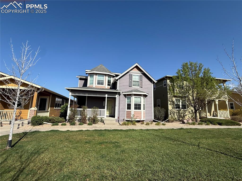 Image 34 of 34: View of front facade featuring a front lawn and covered porch
