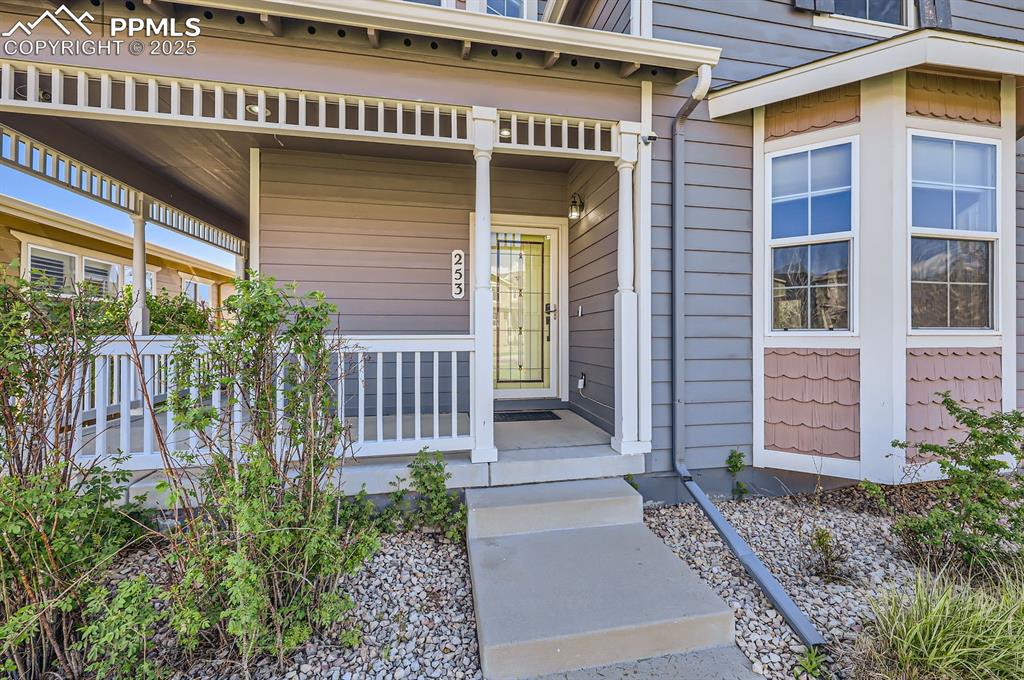 Image 4 of 34: Doorway to property featuring covered porch