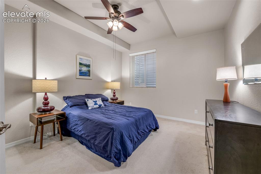 Image 15 of 32: Recessed ceiling with a dark wood-finish ceiling fan and attached lighting