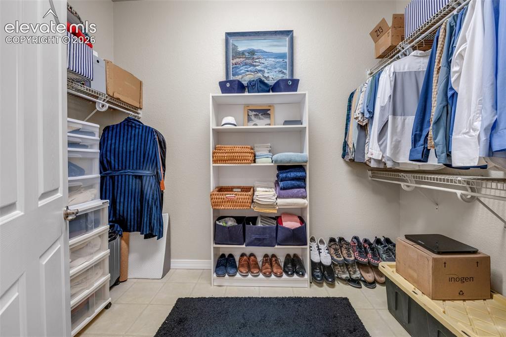 Image 21 of 32: Built-in shelving, wire shelving, and tile flooring