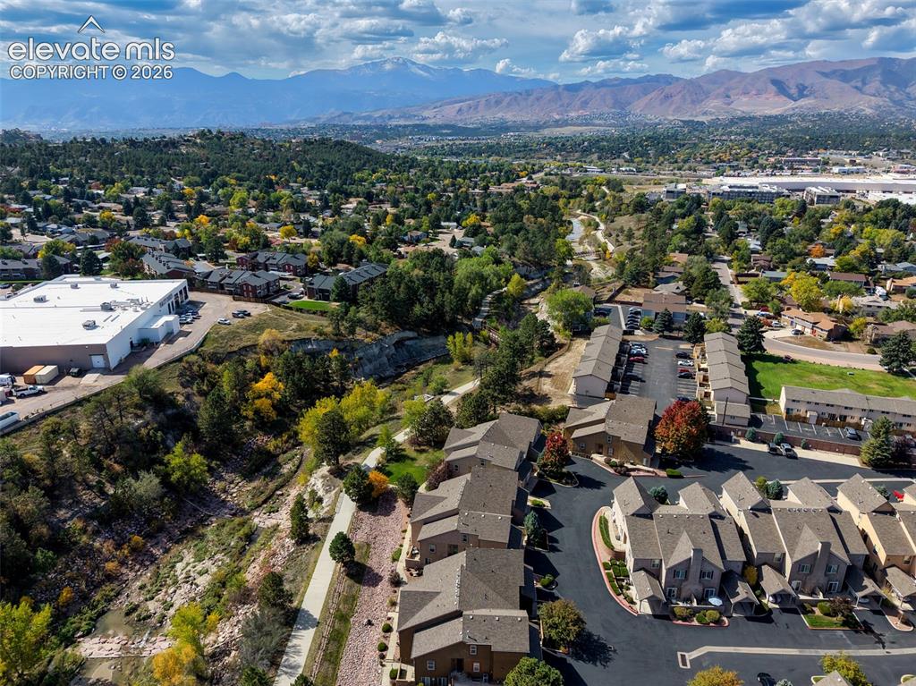 Image 30 of 32: Mountain backdrop, treed landscape, residential area, paved roadways, townh