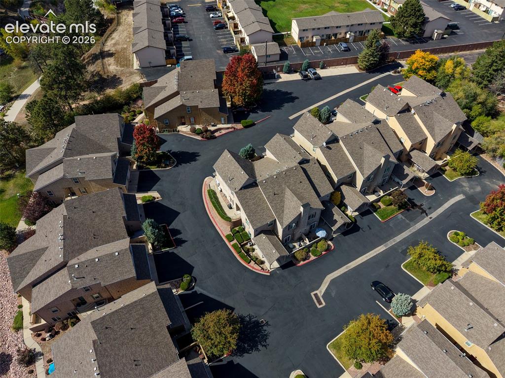 Image 31 of 32: Townhome community featuring multi-story residences, pitched roofs, and lan