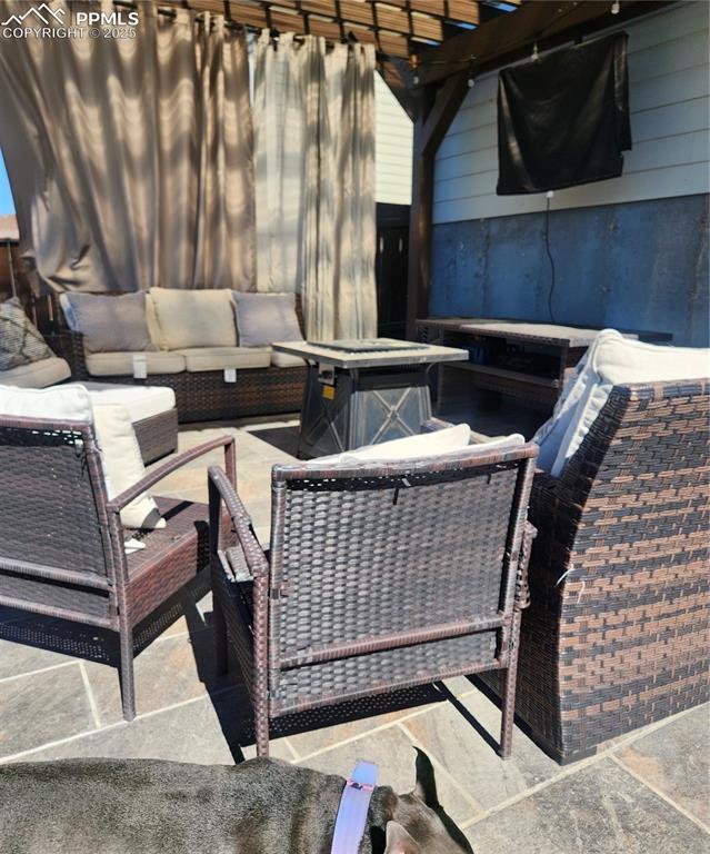 Image 25 of 45: View of patio featuring an outdoor hangout area and a pergola