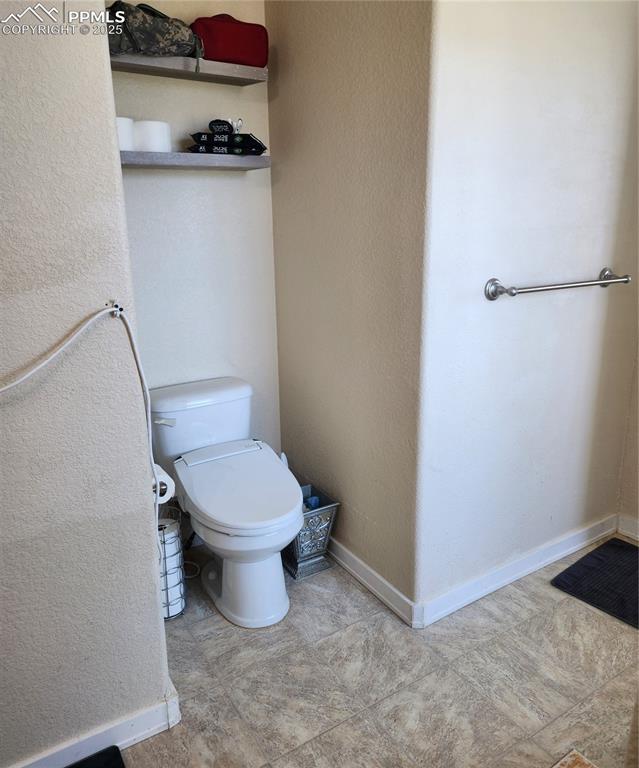 Image 32 of 45: Bathroom featuring a textured wall