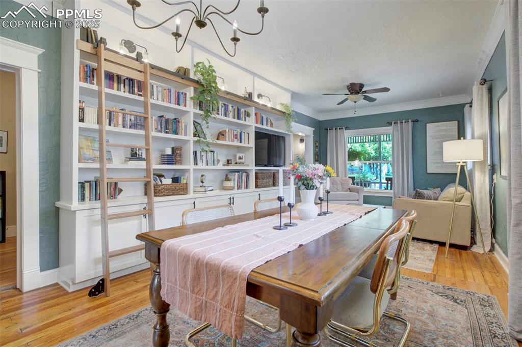 Image 10 of 37: Custom designed rolling library built-in in living room