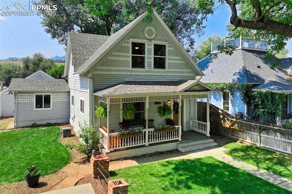 Image 3 of 37: View of front of property with roof with shingles and a wooden deck