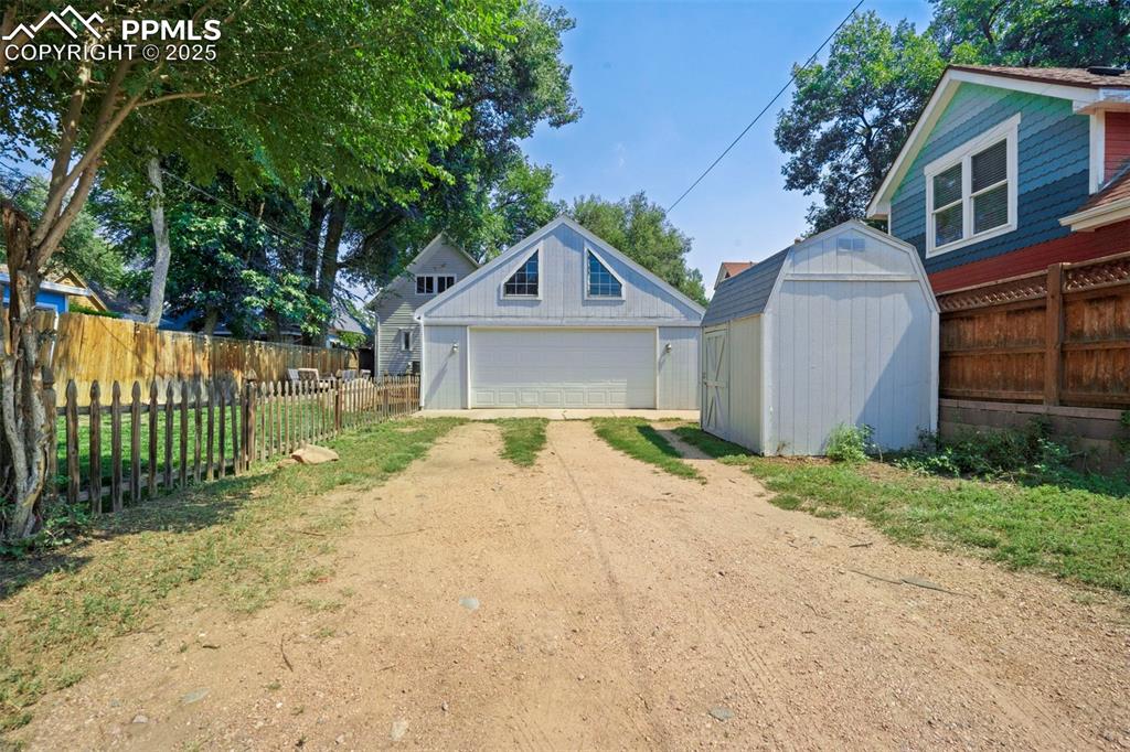 Image 30 of 37: Attached 2 car garage plus storage shed
