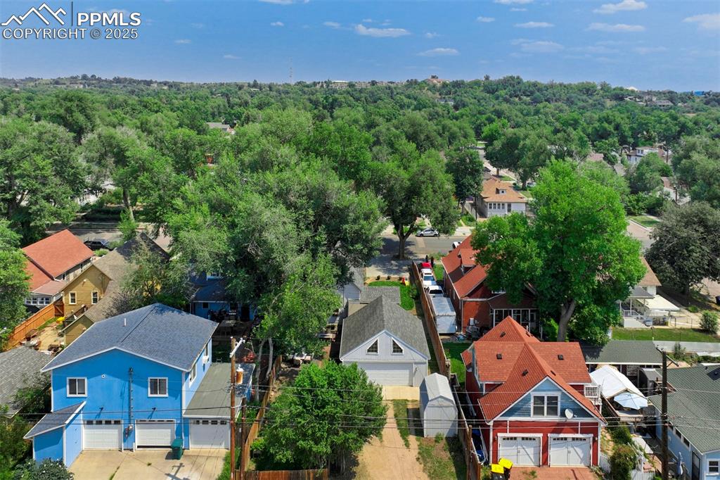 Image 33 of 37: Aerial view of residential area featuring a forest