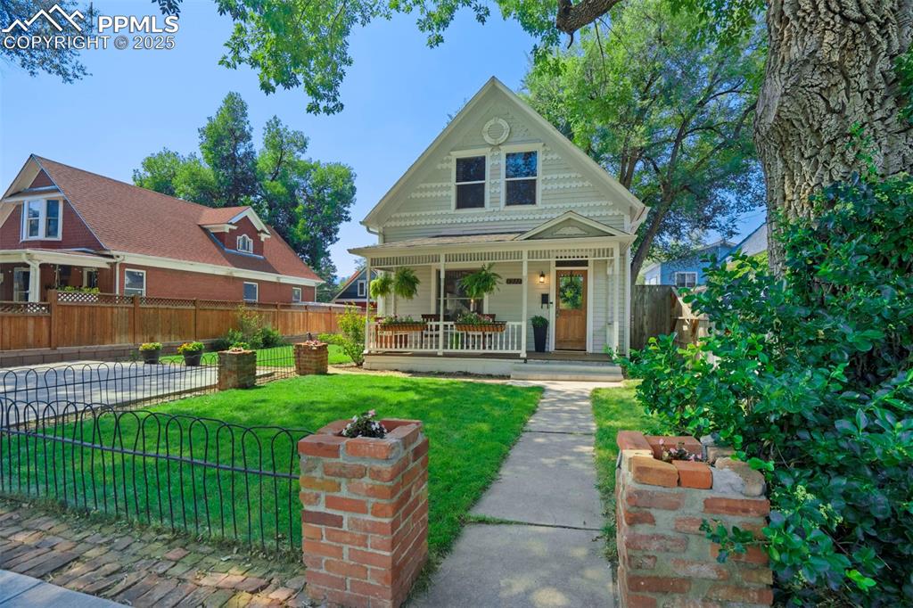 Image 36 of 37: Victorian-style house featuring a porch