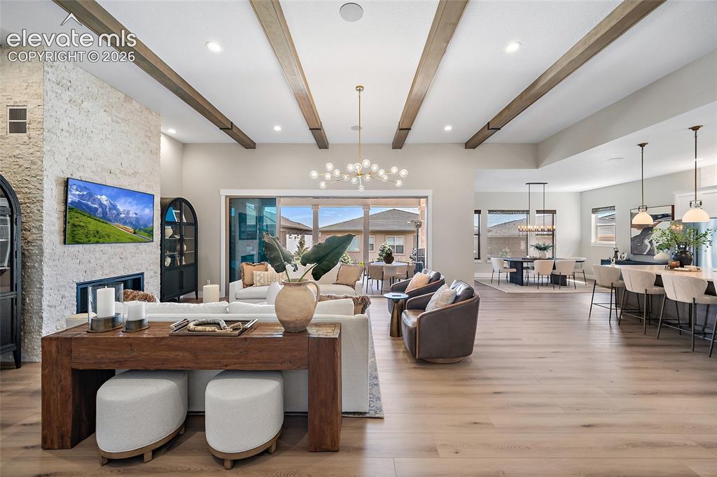 Image 6 of 45: wood-finish beams, integrated fireplace with stone-finish surround, wood-fi