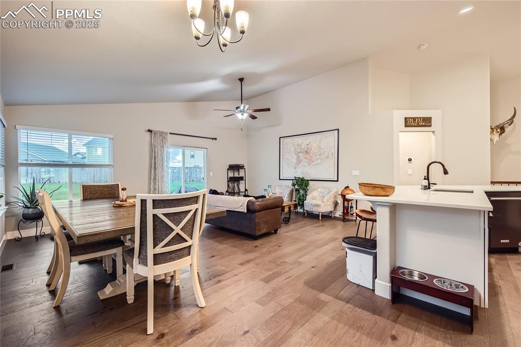 Image 11 of 37: Dining room with vaulted ceiling, light wood-style flooring, a chandelier,