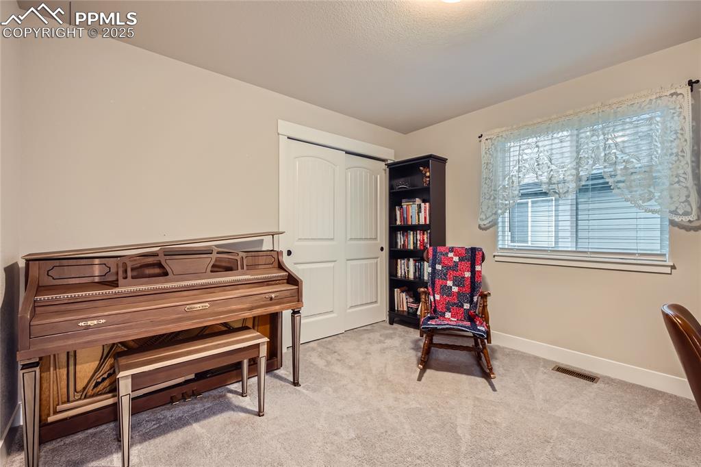 Image 16 of 37: Sitting room with light carpet