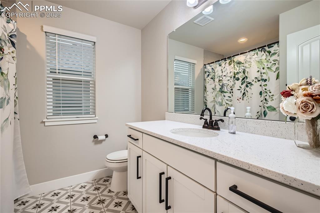 Image 17 of 37: Full bath with vanity, a shower with curtain, and tile patterned floors