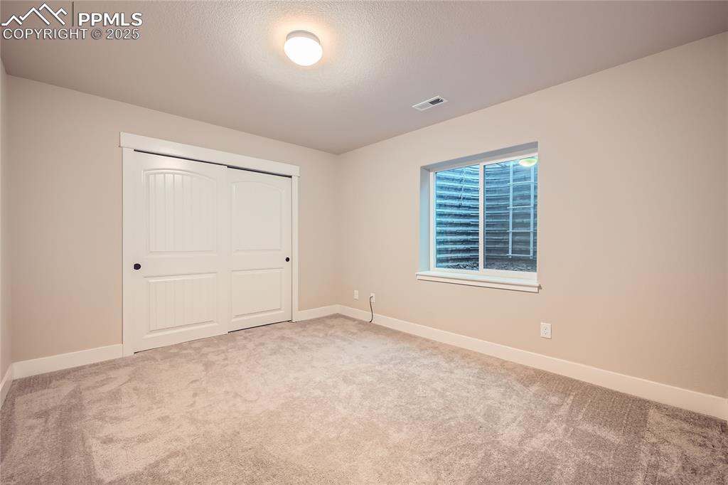 Image 22 of 37: Unfurnished bedroom with carpet and a closet