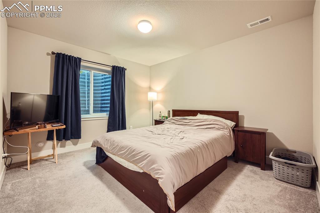 Image 23 of 37: Bedroom with carpet flooring