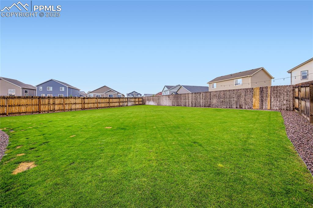 Image 27 of 37: Fenced backyard featuring a residential view