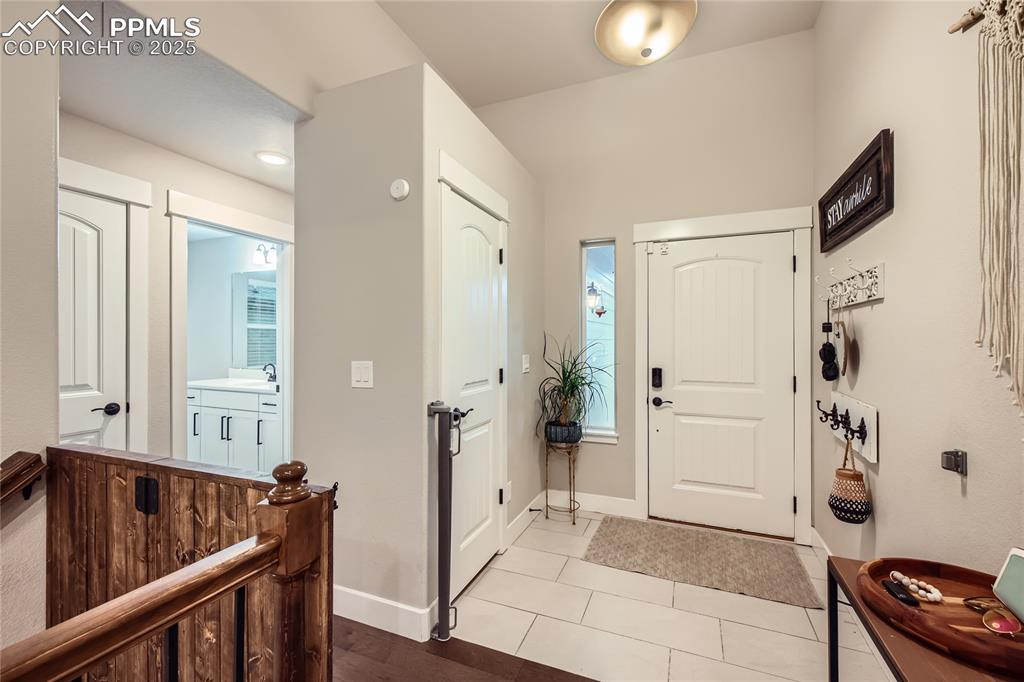 Image 4 of 37: Foyer with baseboards and light tile patterned floors