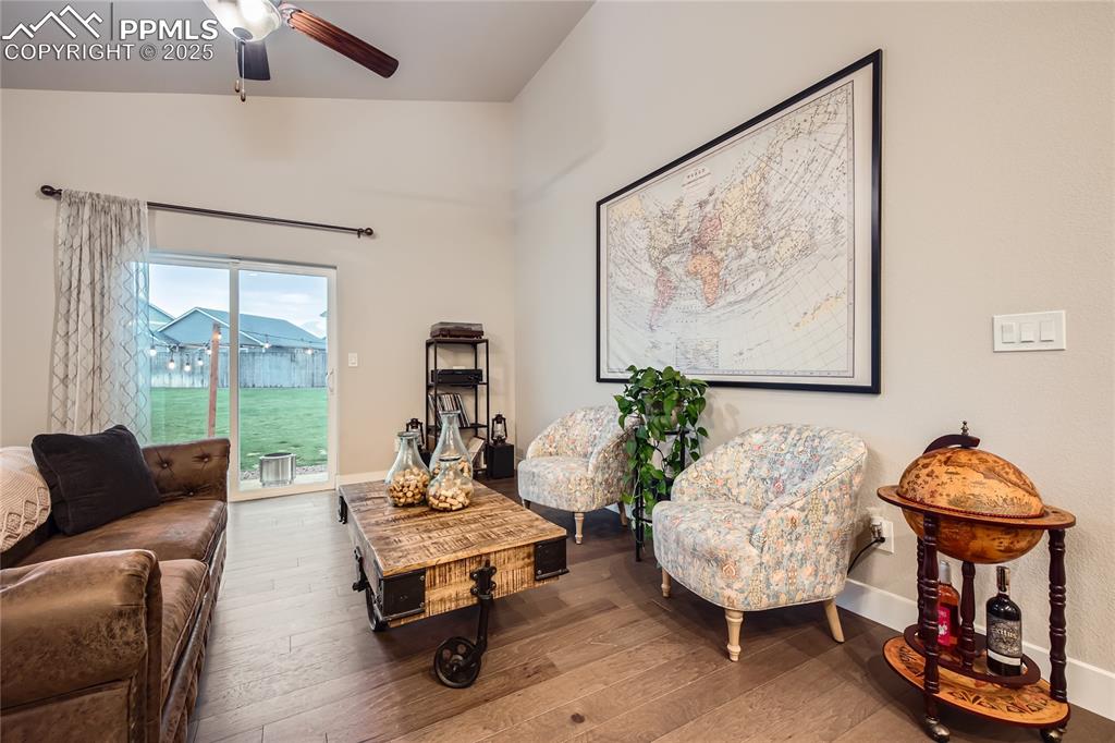 Image 6 of 37: Living area with wood-type flooring and ceiling fan