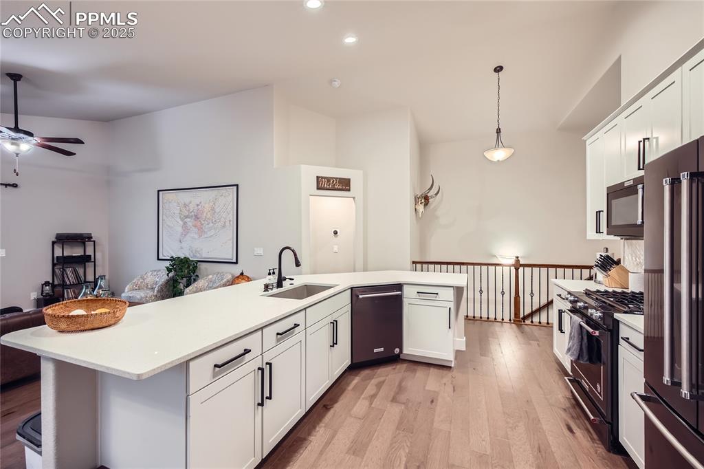 Image 9 of 37: Kitchen featuring dishwashing machine, high quality fridge, black gas stove