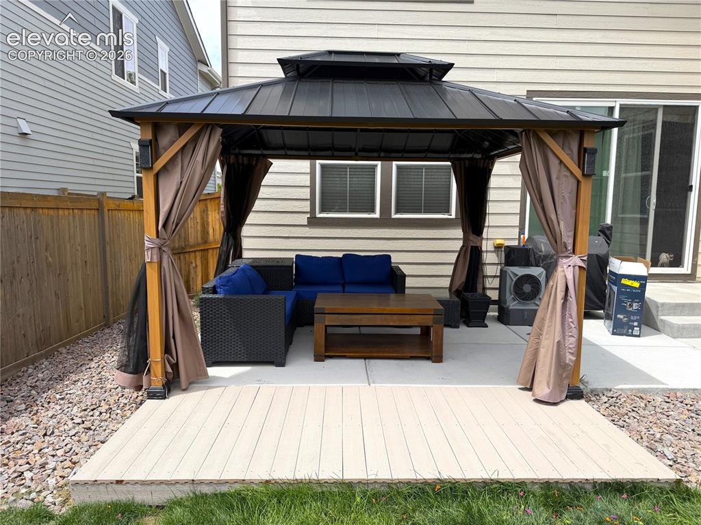 Image 35 of 35: Outdoor gazebo featuring a permanent hard-top metal roof, wooden support po