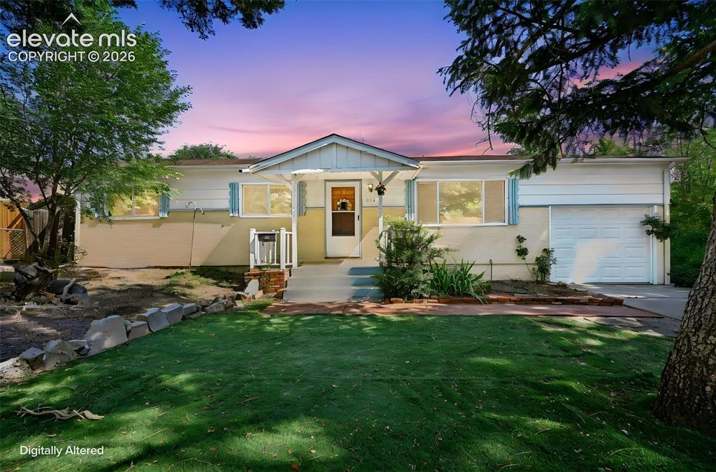 Image 1 of 35: Ranch-style exterior with a covered entry, attached garage, front lawn, and
