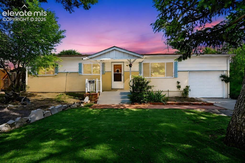 Image 1 of 32: Single-story residence featuring a white and tan exterior, an attached gara