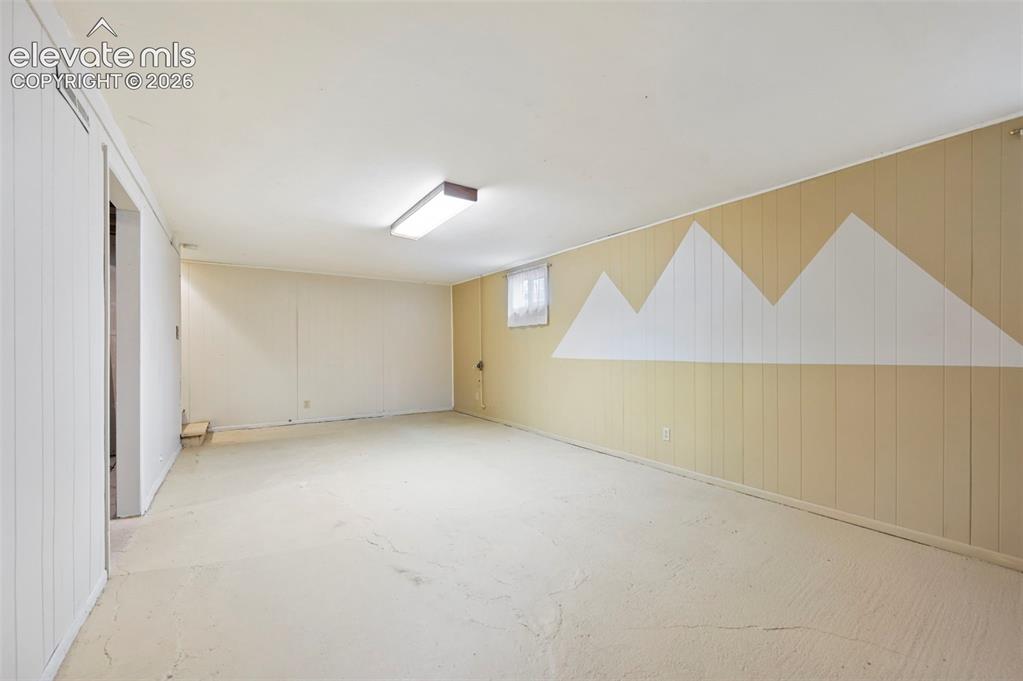 Image 16 of 32: Spacious room featuring light-colored walls, a drop ceiling with recessed l