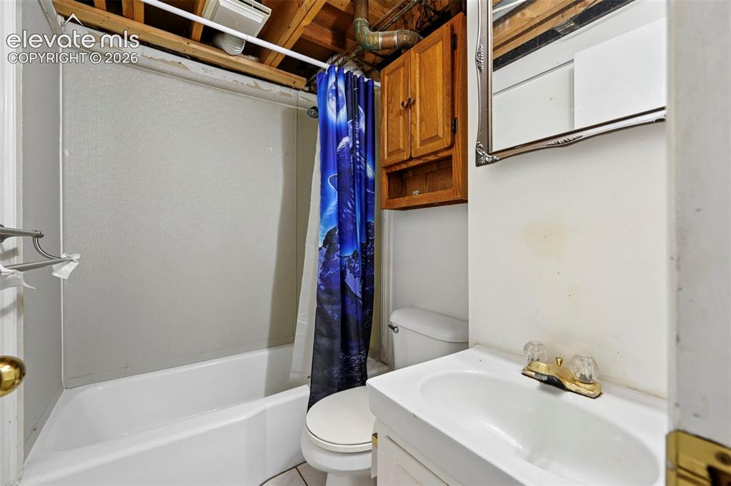 Image 19 of 32: Bathroom featuring a white bathtub, white toilet, and a vanity with a white