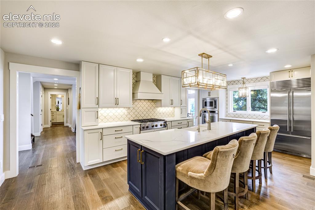 Image 16 of 50: Thoughtfully designed for entertaining with designer quartz countertops, cu