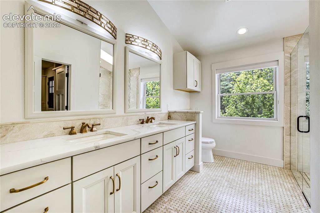 Image 30 of 50: Spa-inspired luxury featuring heated floors, designer finishes, and a spaci