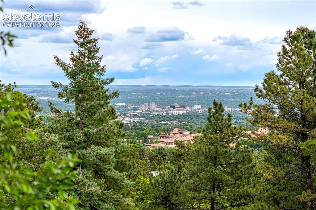 Image 50 of 50: Surrounded by towering pines and backed by iconic Cheyenne Mountain, this r