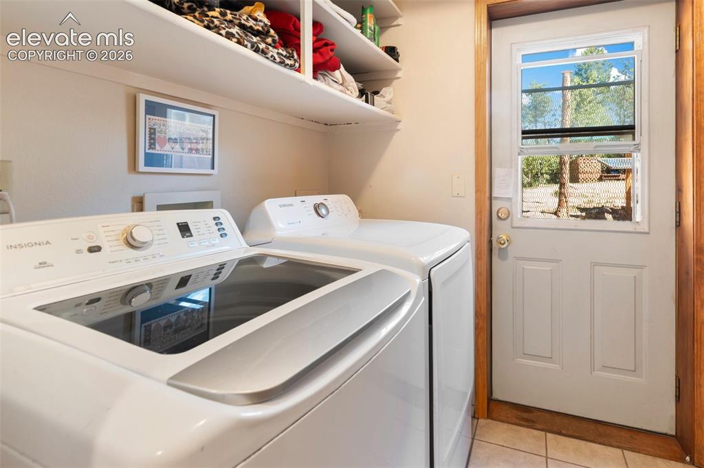 Image 19 of 31: Laundry Room, storage and back yard door.