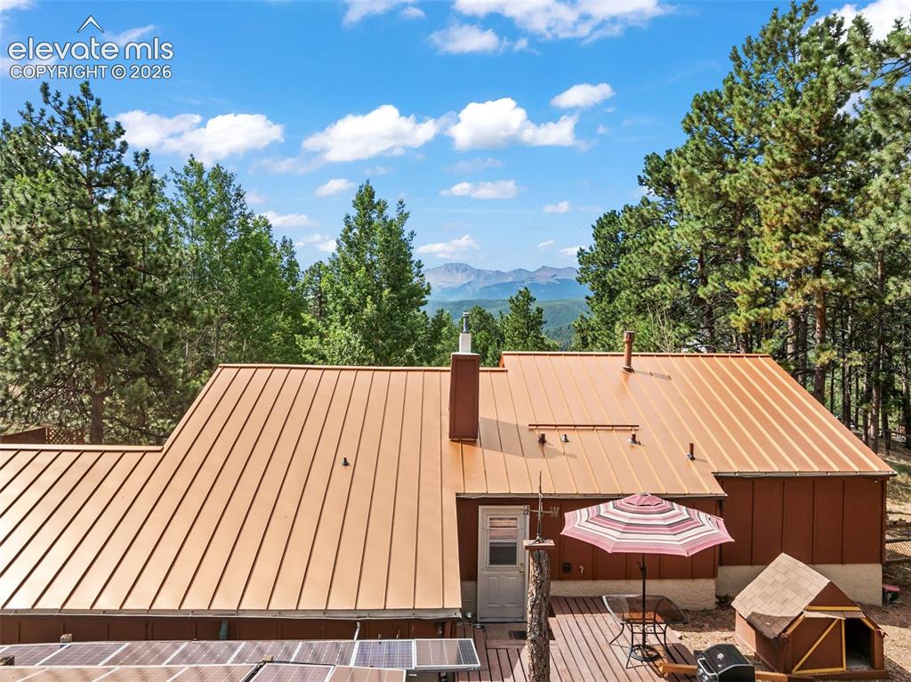 Image 5 of 31: Updgraded metal roof! Pikes Peak in the background!