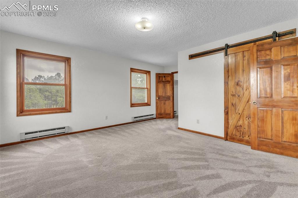 Image 19 of 43: Unfurnished bedroom featuring a baseboard radiator, a baseboard heating uni