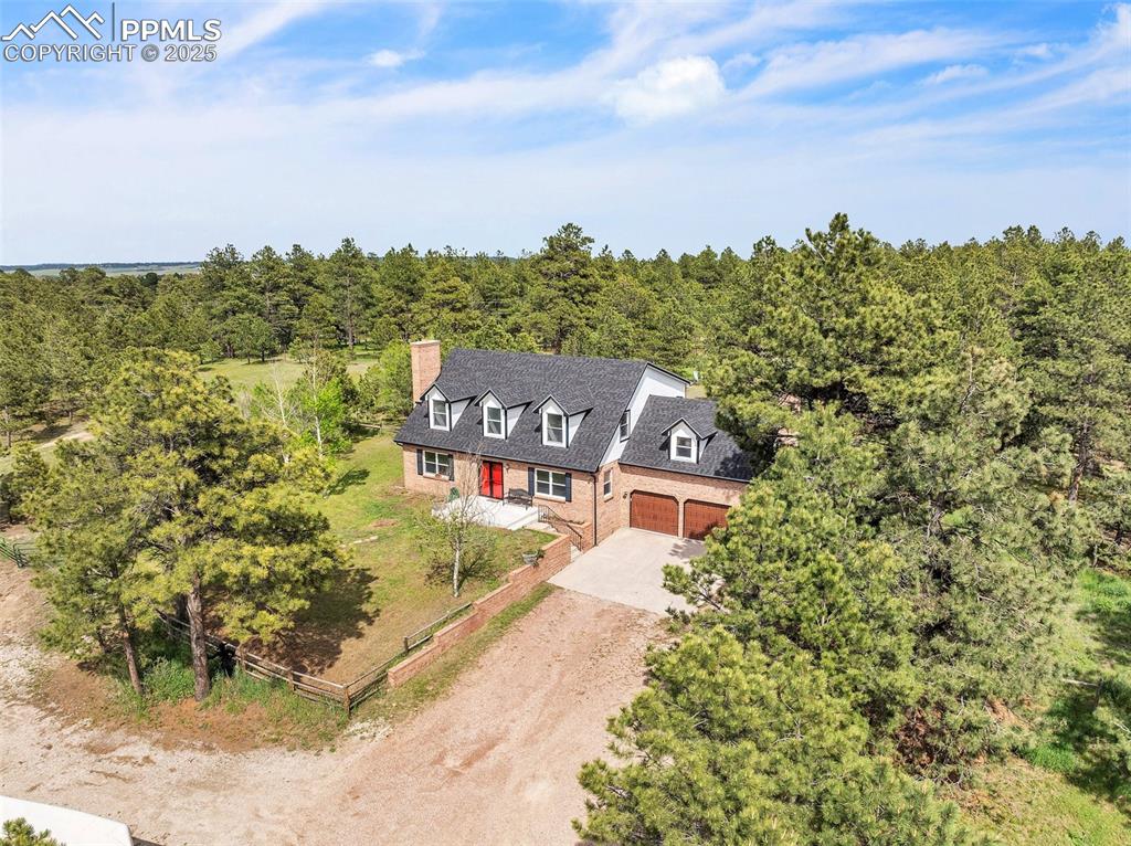 Image 4 of 43: View of subject property with a heavily wooded area