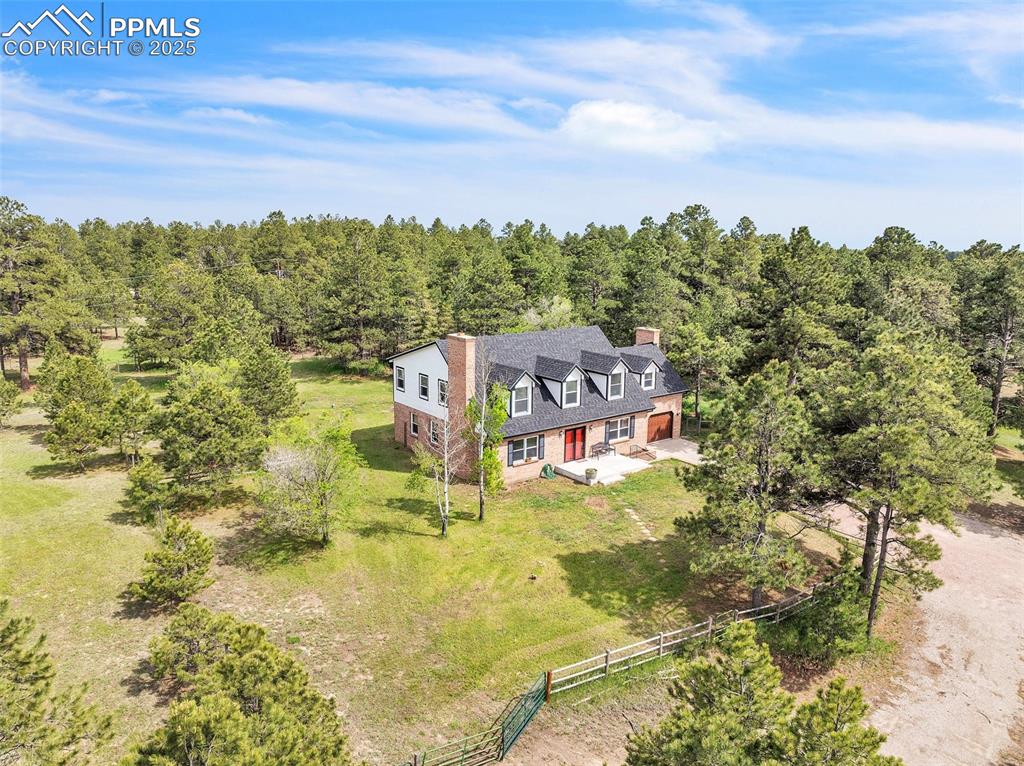 Image 5 of 43: View from above of property featuring a heavily wooded area